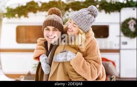 Romantic millennial couple having fun together at winter camping Stock Photo
