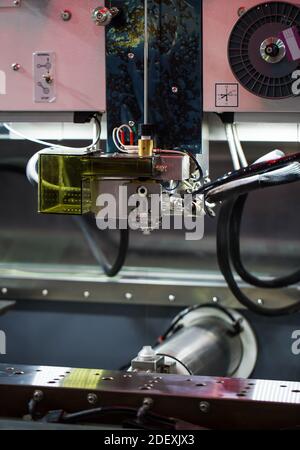 Close up of electrical discharge machining (EDM) wire threader machine. Industrial metalworking machinery Stock Photo