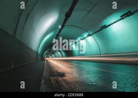 Light trails left behind as traffic moves through a city tunnel in Rome Stock Photo