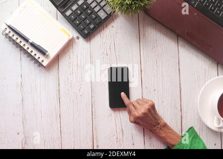 senior women hand using smart phone on table  Stock Photo