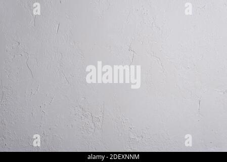 fragment of wall of white decorative plaster texture with grainy fine elements White plaster texture background with grainy detail and relief Stock Photo