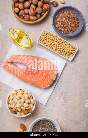 Omega 3 food sources and omega 6 on concrete background top