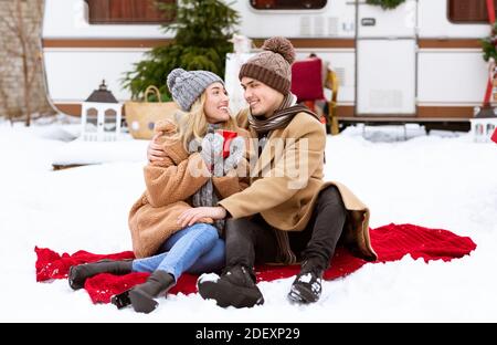 Romantic Young Lovers Enjoying Picnic During Winter Day At Camping Stock Photo