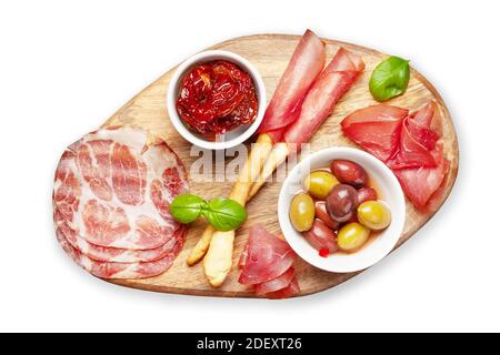 Cheese, meat and olives antipasto. Appetizer selection on wooden board. Top view flat lay. Isolated on white background Stock Photo