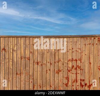 Wooden fence with blue sky background Stock Photo