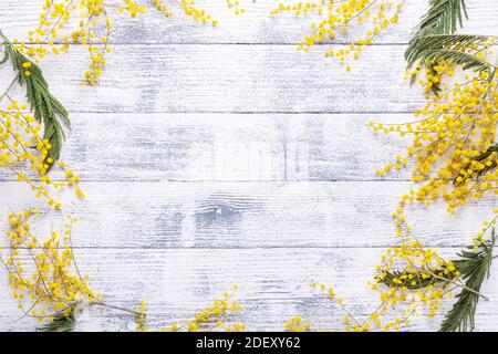 Mimosa flowers on a wooden table. Frame of flowers. Top view. Copy space - Image Stock Photo