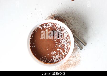 Chocolate Banana Mousse with Coconut Topping on White Background. Stock Photo