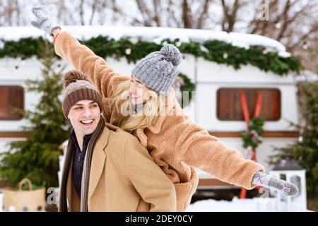 Holiday Fun. Portrait Of Joyful Young Couple Enjoying Date At Winter Campsite Stock Photo