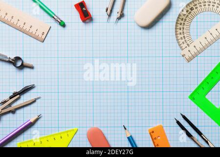 Background from various tools on drawing paper with scale coordinates with copy space in the center, top view. Stock Photo
