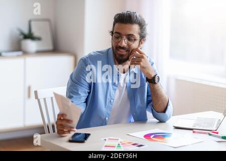 Handsome Western Freelance Designer Choosing Color Palette For New Project Stock Photo