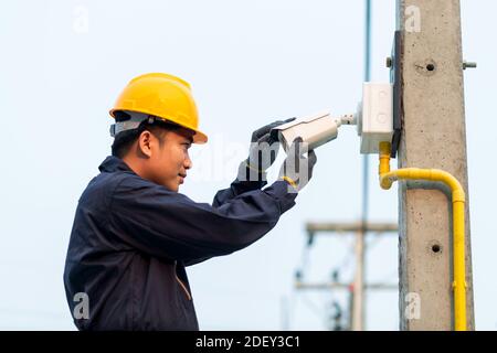 Maintenance technician checking CCTV camera, After-sales service concept Stock Photo