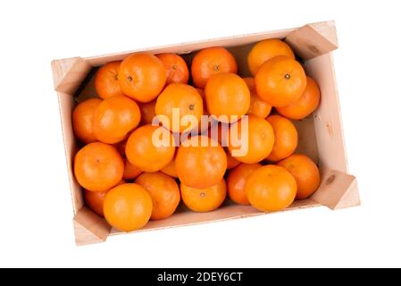 above view of wooden crate filled with tangerines or clementines isolated on white background Stock Photo