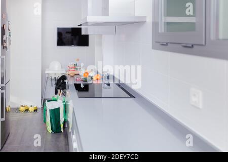 Kitchen of a house with products to prepare healthy food and some bags Stock Photo