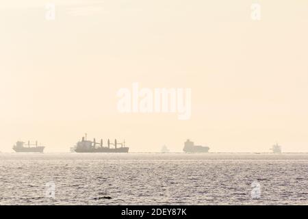 Cargo ships as seen in Manila Bay in the Philippines Stock Photo