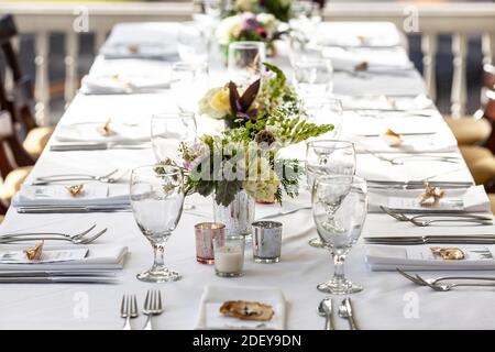 Classy table set up for meal at an outdoor wedding reception Stock Photo
