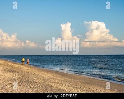 People walking on Gulf of Mexico beach on Sanibel Island Florida in the United States Stock Photo