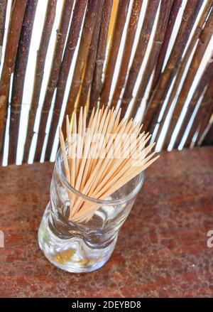 A vertical shot of toothpick sticks in a glass cup Stock Photo