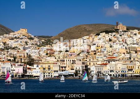 View of sailing boats with the town of Hermoupoli in the background, Syros island, Greece, April 9 2006. Stock Photo
