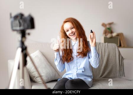 Teen Girl Recording Her Beauty Blog, Showing Foundation Stock Photo