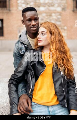 Multiethnic young couple having romantic moments together in the street. Multicultural couples concept Stock Photo