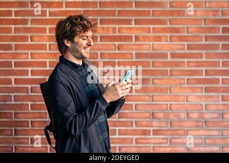Stock photo of handsome man using his cellphone in the street. Stock Photo