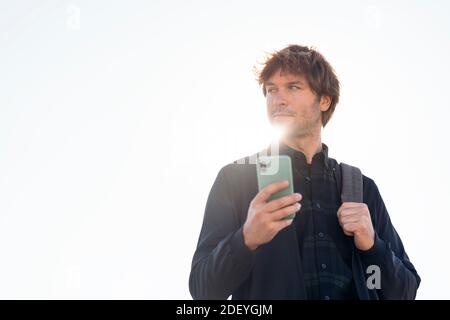 Stock photo of handsome man using his cellphone in the street. Stock Photo