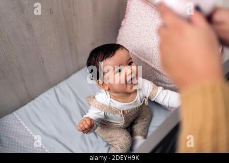 Stock photo of cute and happy baby playing with her mom at home. Stock Photo