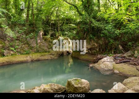 black river that comes from the marmore waterfalls in the middle of nature Stock Photo