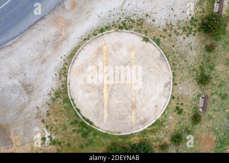 Helicopters landing area. Aerial drone view of helipad sign. Heliport signal with yellow color letter H on ground, make us feel safe in case of emerge Stock Photo