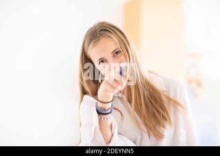 young woman with pencil and folio in an office working Stock Photo