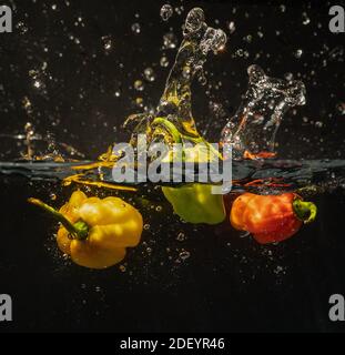 Habanero peppers splash into fresh water Stock Photo