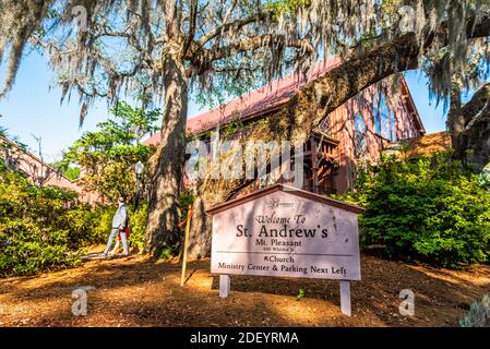 Mount Pleasant, USA - May 11, 2018: St. Andrews church building in Charleston, South Carolina area with oak trees spanish moss and people walking by s Stock Photo