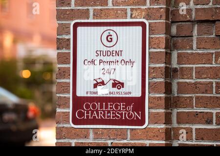 Charleston, USA - May 12, 2018: Downtown city road street in South Carolina with closeup of student parking permit sign for college or university Stock Photo