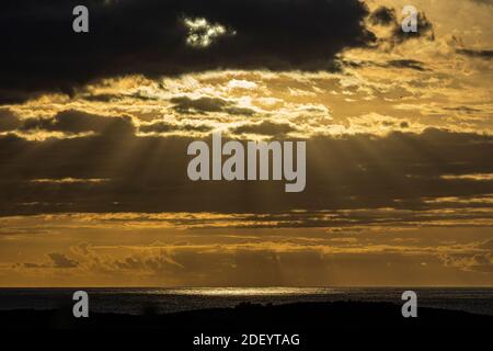 Dramatic light through cumulus clouds over the atlantic ocean in Palm Mar, Tenerife, Canary Islands, Spain Stock Photo