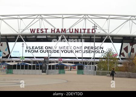 London, UK. 02nd Dec, 2020. A woman walking towards the London Stadium displaying Social distancing guidelines. Credit: SOPA Images Limited/Alamy Live News Stock Photo