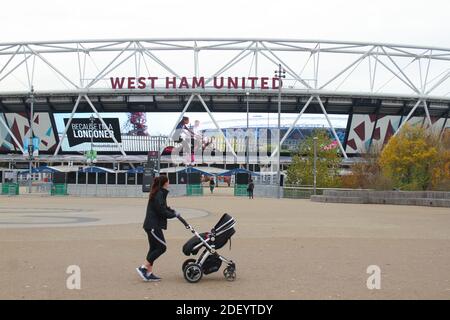 London, UK. 02nd Dec, 2020. A woman pushing a baby stroller walking past the London Stadium showing Social distancing guidelines. Credit: SOPA Images Limited/Alamy Live News Stock Photo