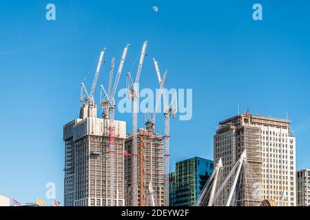 London, UK - June 22, 2018: Southbank riverside place luxury buildings under construction with many cranes on sunny summer day by modern skyscrapers Stock Photo