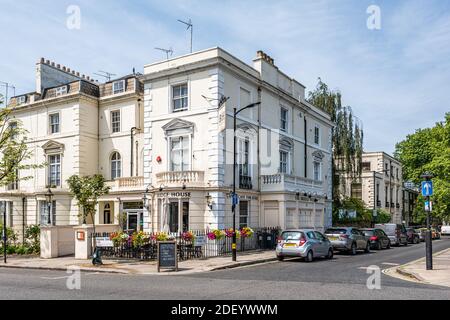 London, UK - June 24, 2018: Westbourne Delamere terrace street road with Bridge House Canal cafe theater with people sitting outdoor in City of Westmi Stock Photo