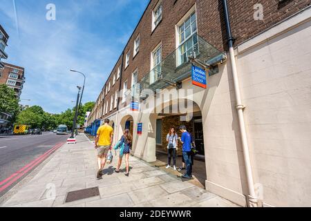 London, UK - June 24, 2018: Entrance to London Business School university college sign with people students standing by gift store shop in summer at P Stock Photo