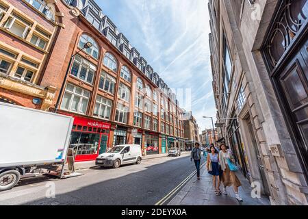 London, UK - June 24, 2018: Wardour street road with people walking by stores, shops and restaurants in summer at Soho, West End neighborhood area of Stock Photo