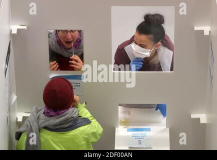 A student has an asymptomatic test using lateral flow antigen at a test centre at Edinburgh University ahead of being allowed to travel home for the Christmas holidays. Stock Photo