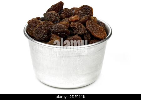 raisins in an aluminium bowl isolated on white background Stock Photo