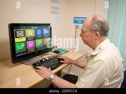 A man using a computer screen for visually impaired people Stock Photo