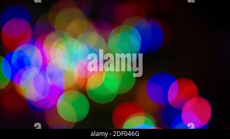 Defocused multi colored christmas blurred lights night abstract bokeh background Stock Photo