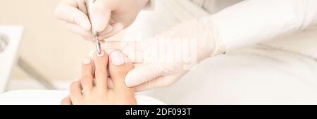 Classic pink wedding toe nail manicure on white backdrop. Spa treatment concept Stock Photo