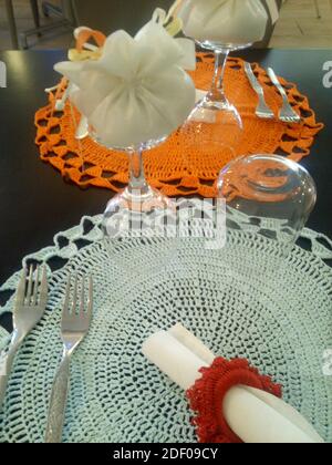 table of a restaurant set with crochet tablecloths for a baptism Stock Photo