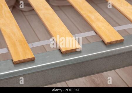 close up of birch slats on the metal frame of the bed. High quality photo Stock Photo