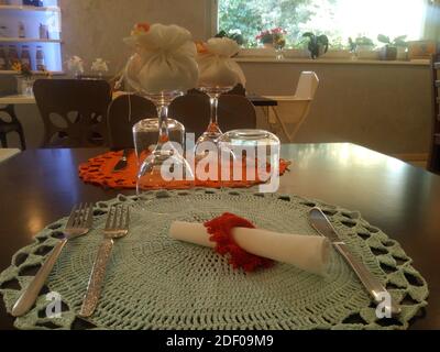 table of a restaurant set with crochet tablecloths for a baptism Stock Photo