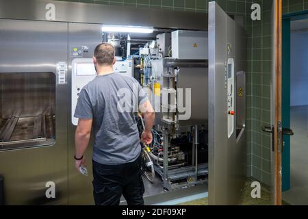 a customer service representative repairs a steam sterilizer in a hospital Stock Photo