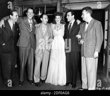Cinematographer RUDOLPH MATE PHIL SILVERS Songwriter SAMMY CAHN RITA HAYWORTH GENE KELLY and Director CHARLES VIDOR on set candid during filming of COVER GIRL 1944 director CHARLES VIDOR music Jerome Kern Columbia Pictures Stock Photo